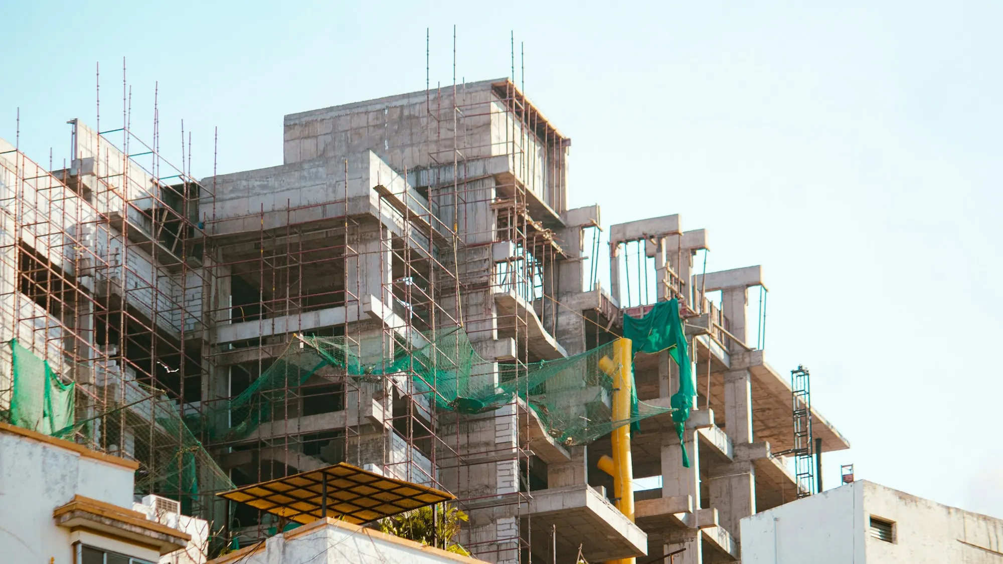 A residential building wrapped in scaffolding during construction